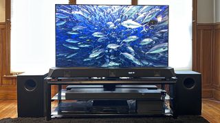 Nakamichi Dragon soundbar system in living room with undersea image of fish on screen