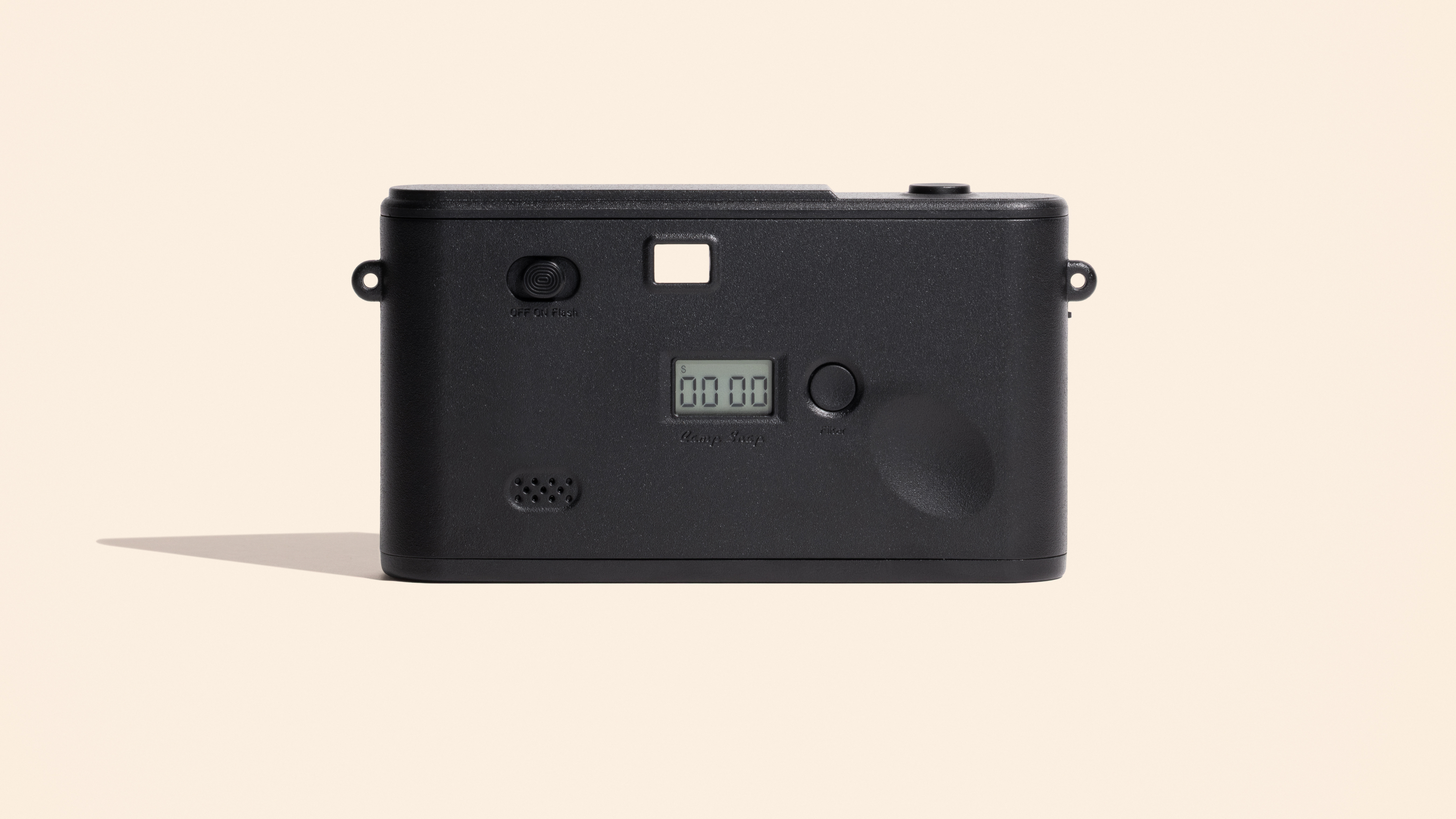 Photograph of Camp Snap 2 small digital compact camera in white rear, showing screen-free back with only a shot counter