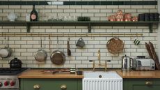 rustic green kitchen with wooden worktops and metro tiles on the wall with pot hanging racks and ceramic sink