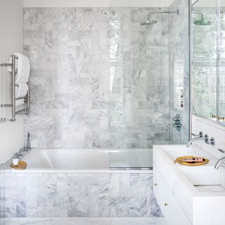white marble bathroom with bathtub