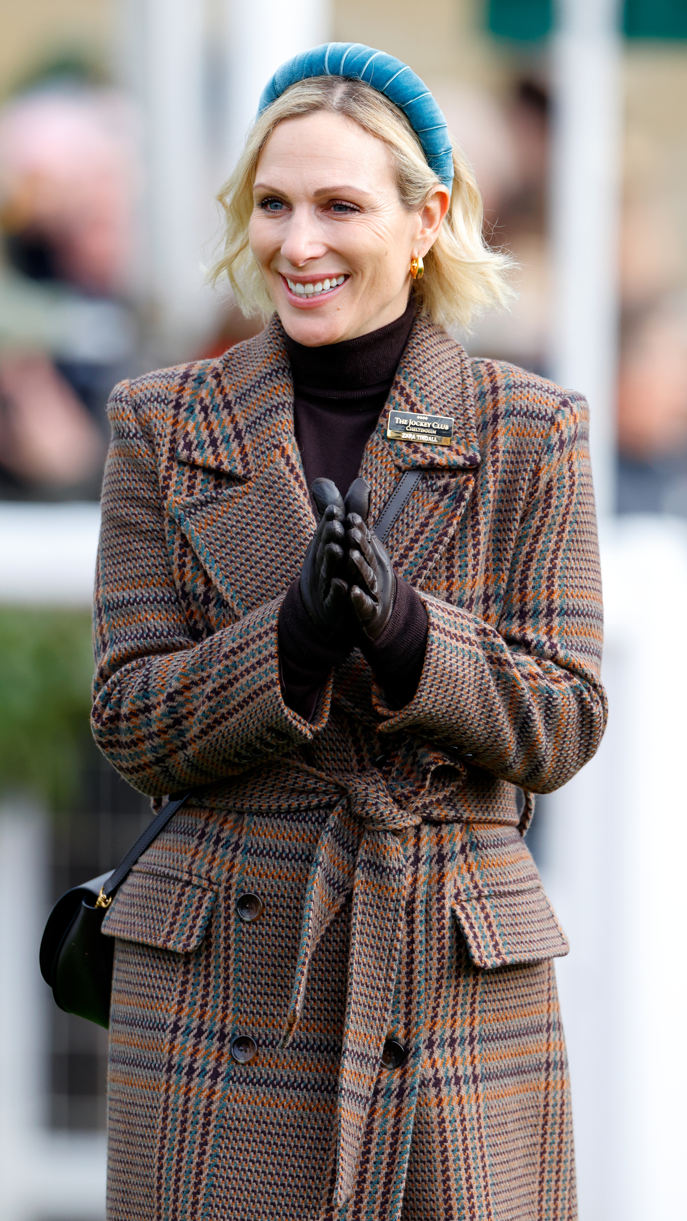 Zara Tindall smiles and claps her hands together as she attends the New Year's Day Racing Meet at Cheltenham Racecourse on January 1, 2026 in Cheltenham
