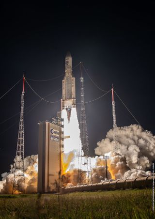 Liftoff of Ariane 5 VA261 into the black night sky at Europe's Spaceport in French Guiana.