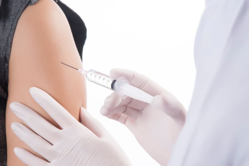 A nurse gives a person a vaccine.