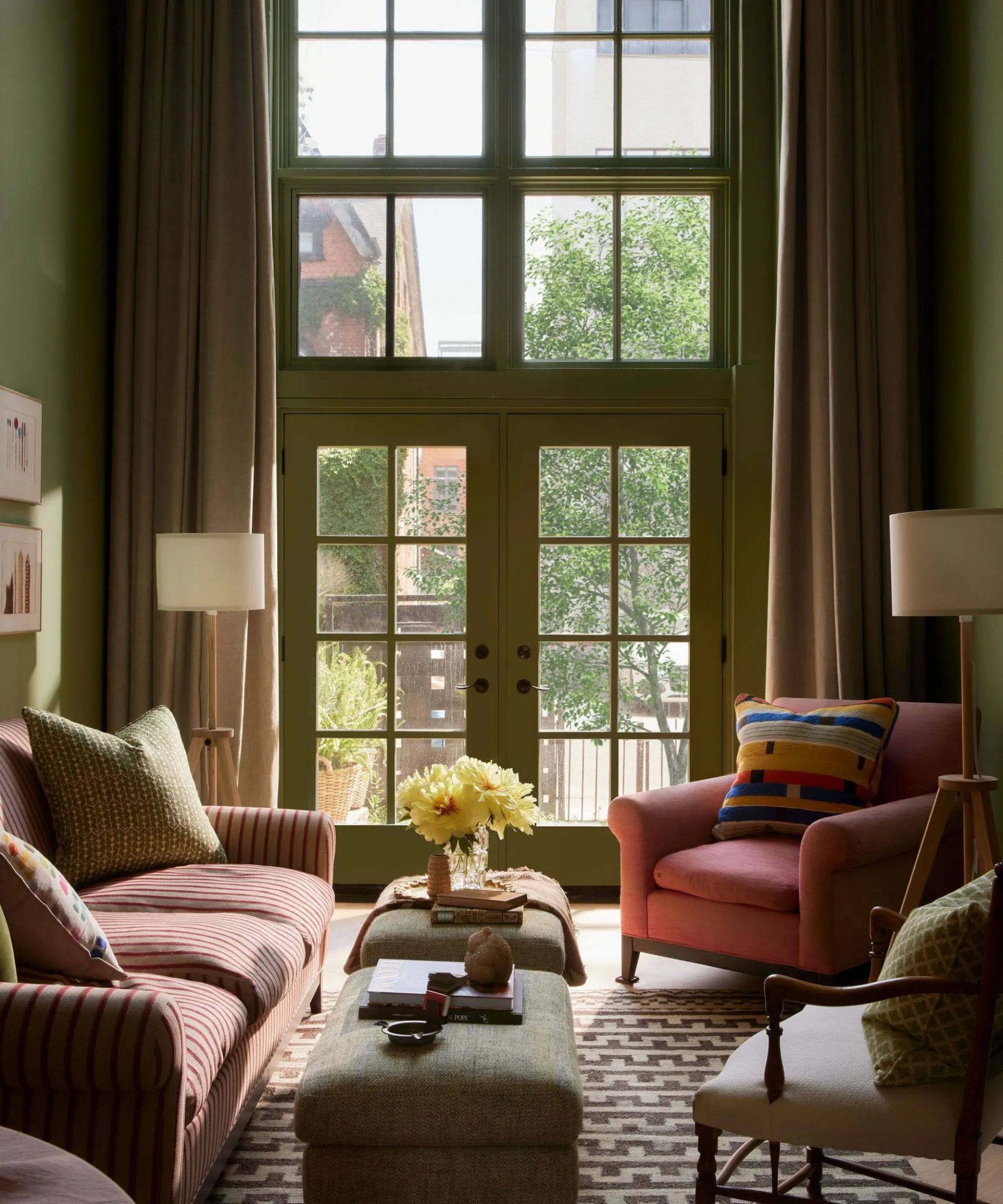 A green living room with pink furniture