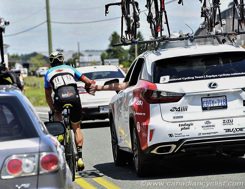 Svein Tuft taking a feed from the team car