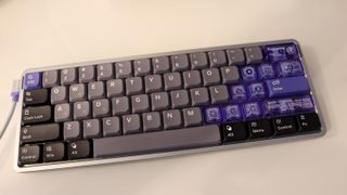 NuPhy Air60 HE gaming keyboard on a desk with RGB enabled.