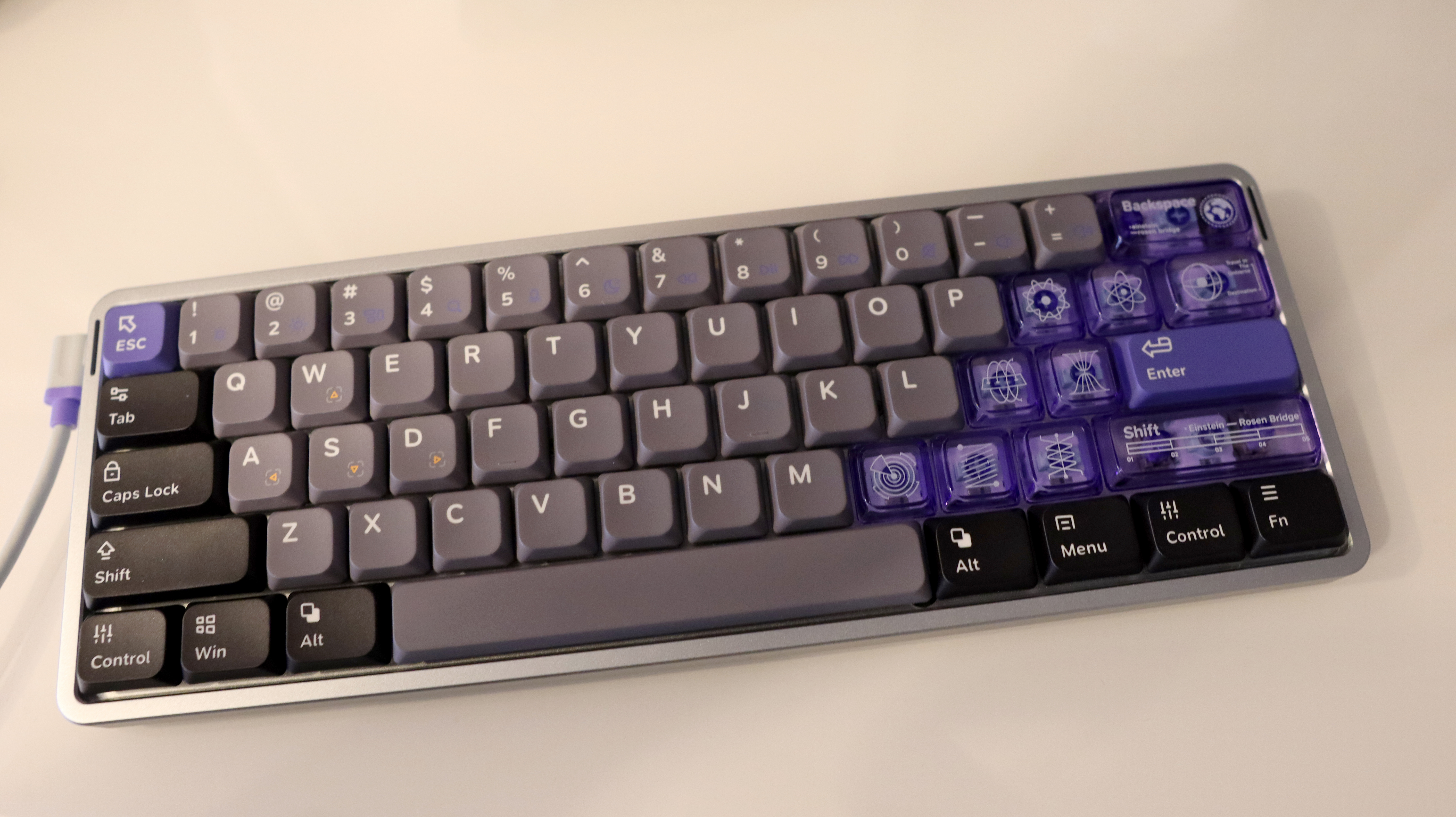 NuPhy Air60 HE gaming keyboard on a desk with RGB enabled.