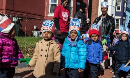 School children walk past a polling station in Washington, D.C. on Nov. 6.: The high school graduation rate in America is just above 75 percent, which is well below that of many other first-w
