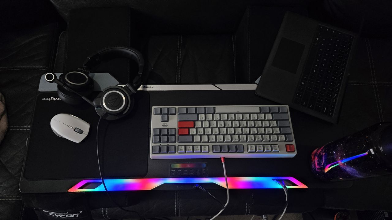 Couchmaster Cycon3 set-up on a sofa with a keyboard and mouse.