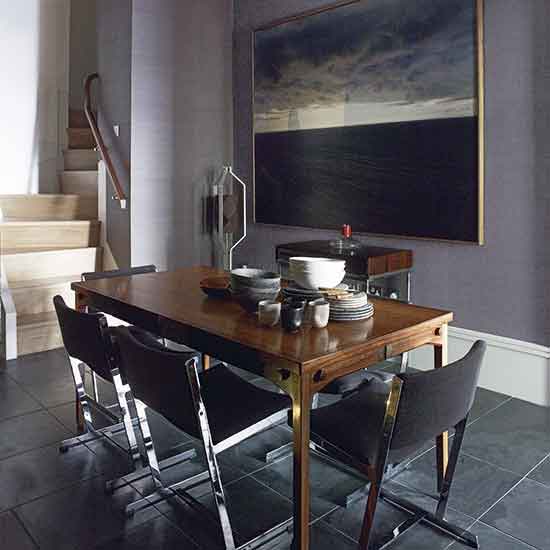 dining table with chairs and bowls on plates with frames on wall