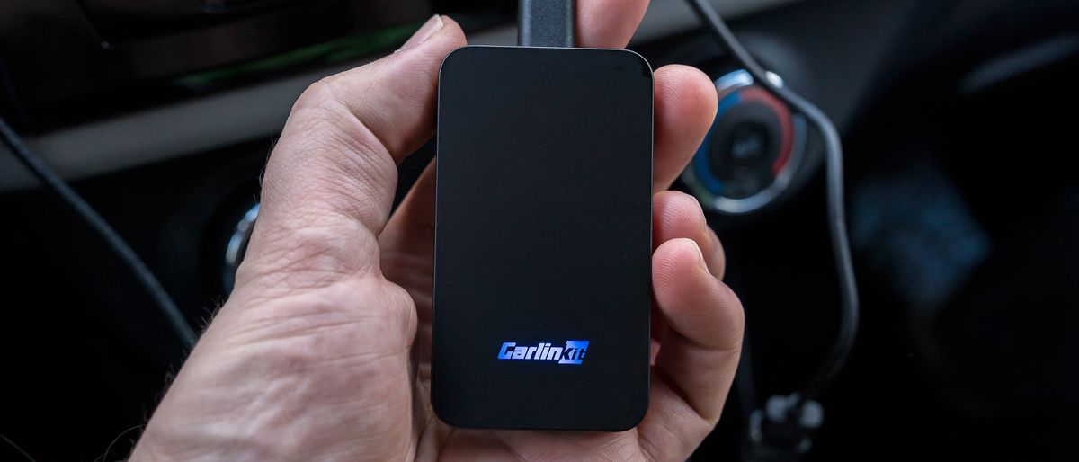 Carlinkit 5.0 (2air) unit in hand while connected to vehicle.