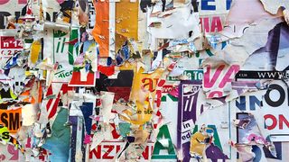 An image of a wall with layers of torn posters using different fonts to represent the importance of font licensing