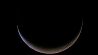 An image of Mars captured by NASA's Psyche spacecraft that shows the entire planet but in the shape of a crescent thanks to a thin slice of sunlight at the bottom of the planet