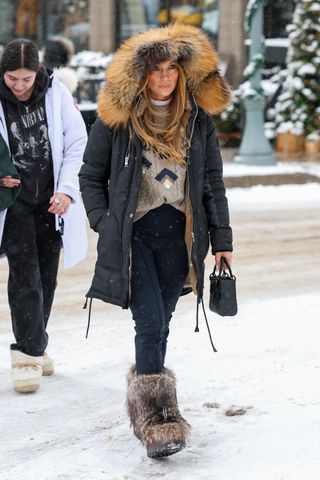 Jennifer Lopez was seen making her way through heavy snow on Christmas Day to dine at the White House restaurant in Aspen wearing fur yeti boots and a lady dior bag