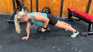 Lillie Bailey demonstrating the renegade row exercise with a dumbbell