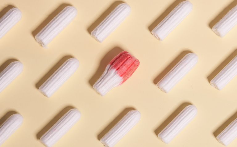 Directly Above Shot Of Tampons Against Beige Background