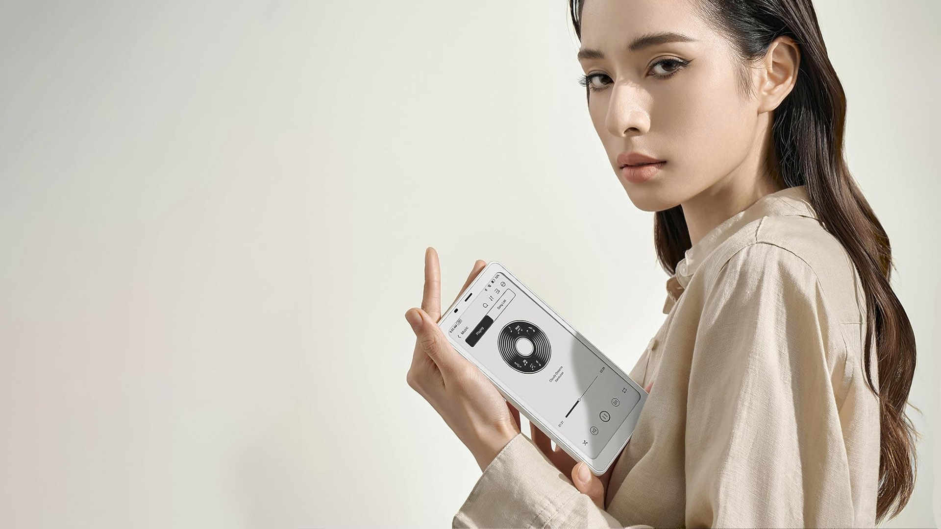 A woman holding the Boox Palma 2
