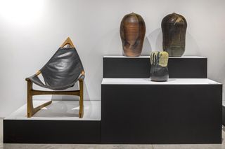 A chair on the left and series of vessels on the right
