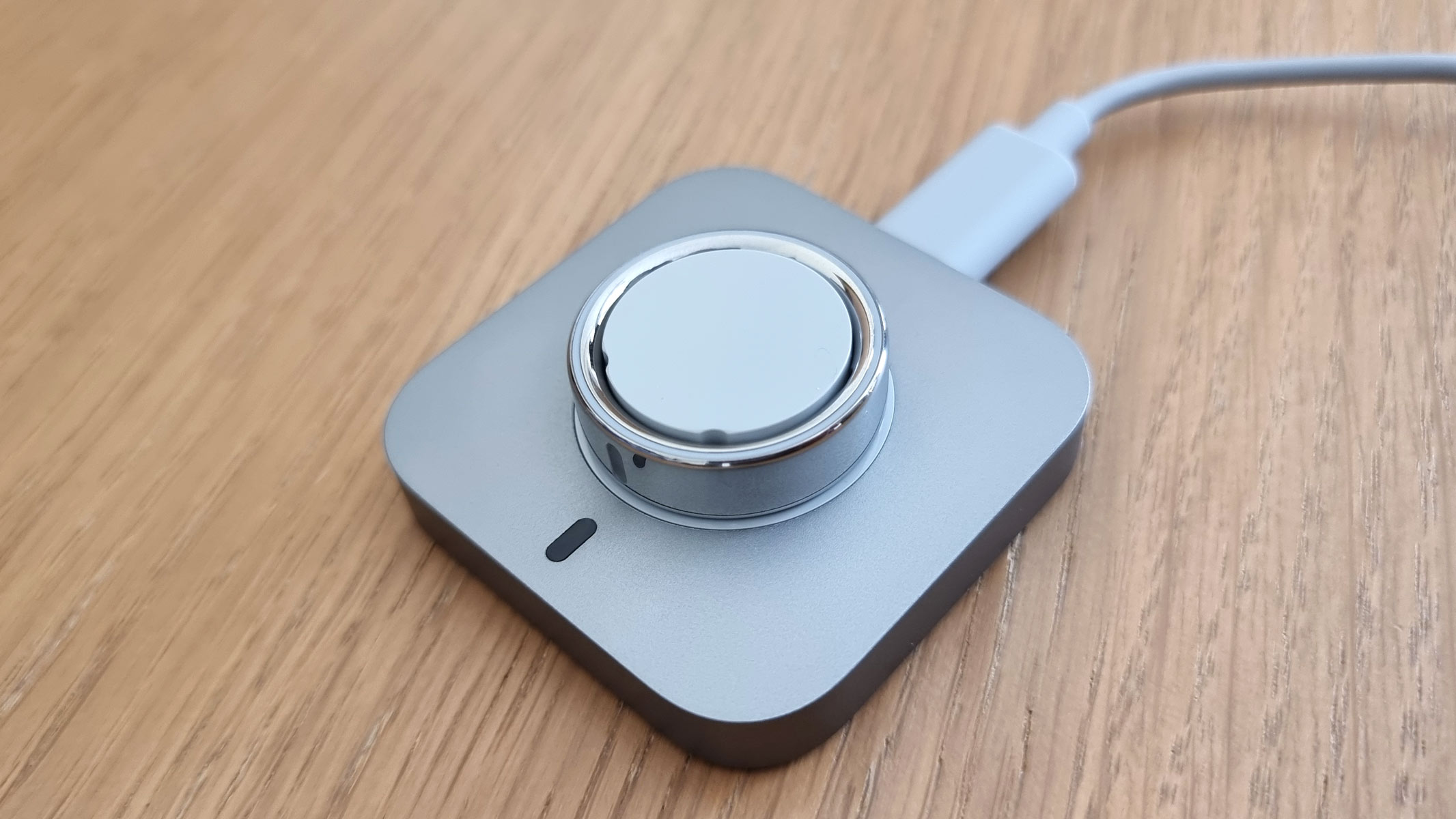 A close-up image of the Oura Ring Gen 4 charging up on the charging pod