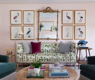 pink spring living room with antique mirror and gallery wall with a floral couch