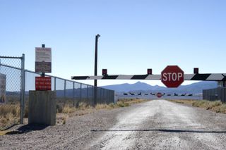 a gate with a stop sign in the deserted