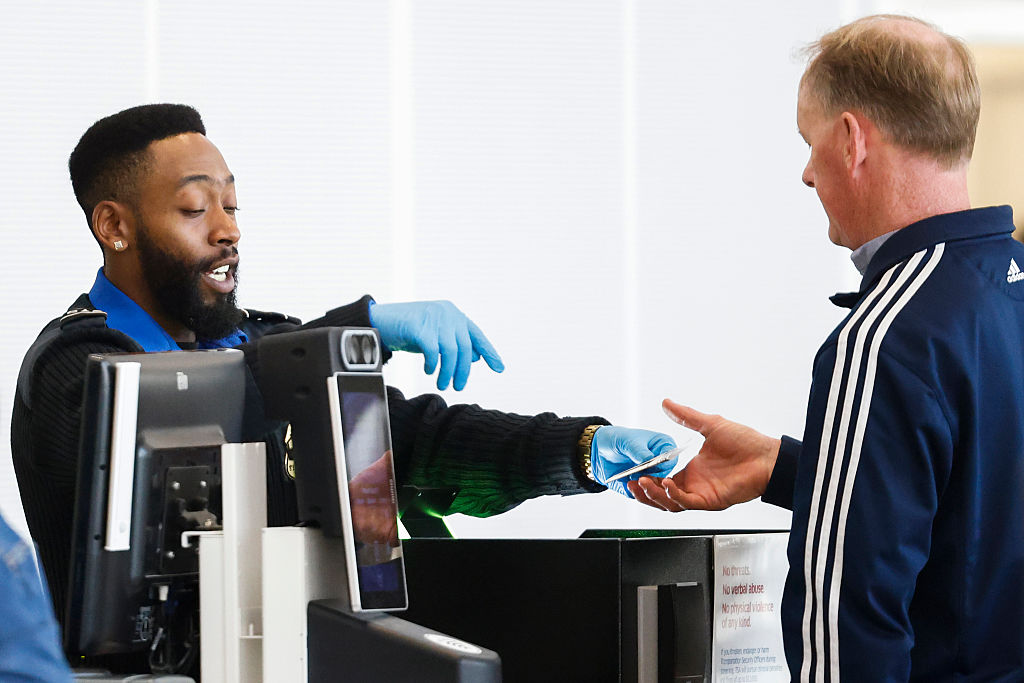 TSA agent returning a traveler's ID