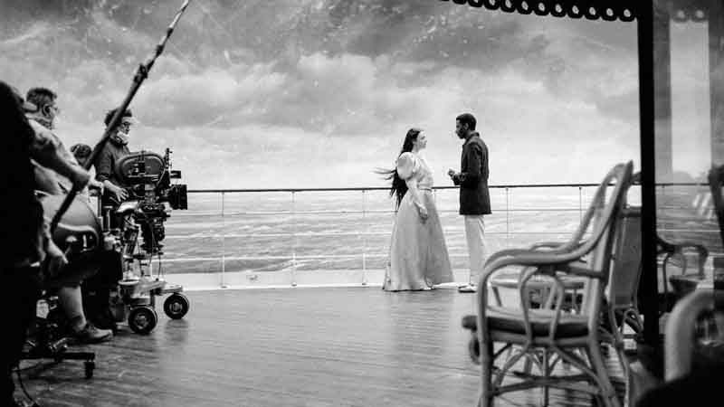 A scene from &quot;Poor Things&#039; in front of a VR set of an ocean on a cruise ship. 