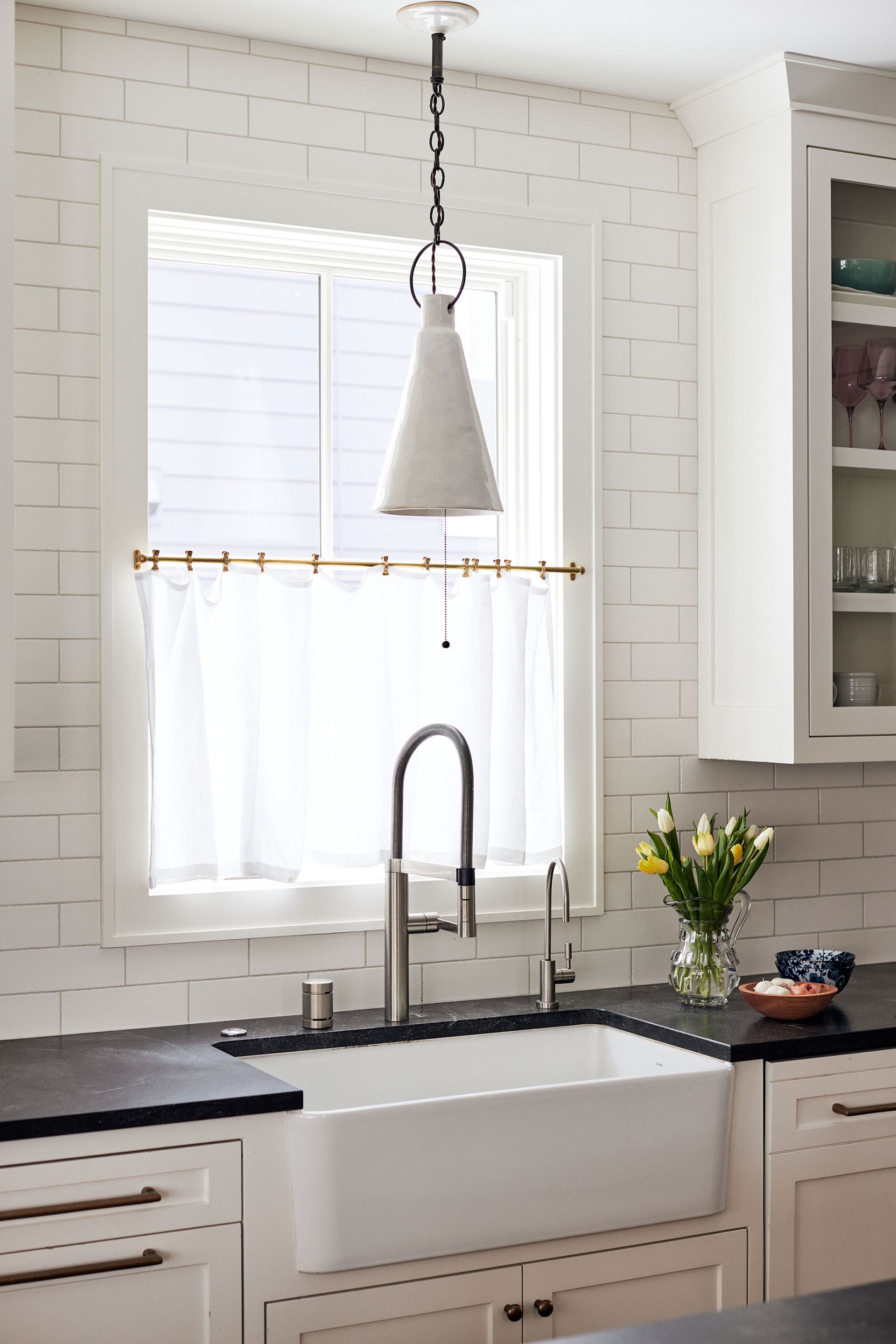 Gauze and brass rod window treatment in kitchen
