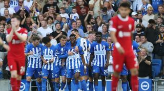 Liverpool's Andy Robertson and Luis Diaz look on as Brighton celebrate Simon Adingra's goal in the teams' Premier League clash at the Amex in October 2023.