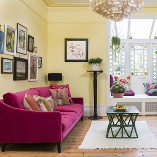 Yellow living room with pink sofa