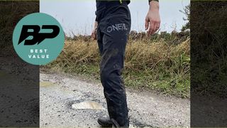 Lower half of man on path wearing mountain bike trousers