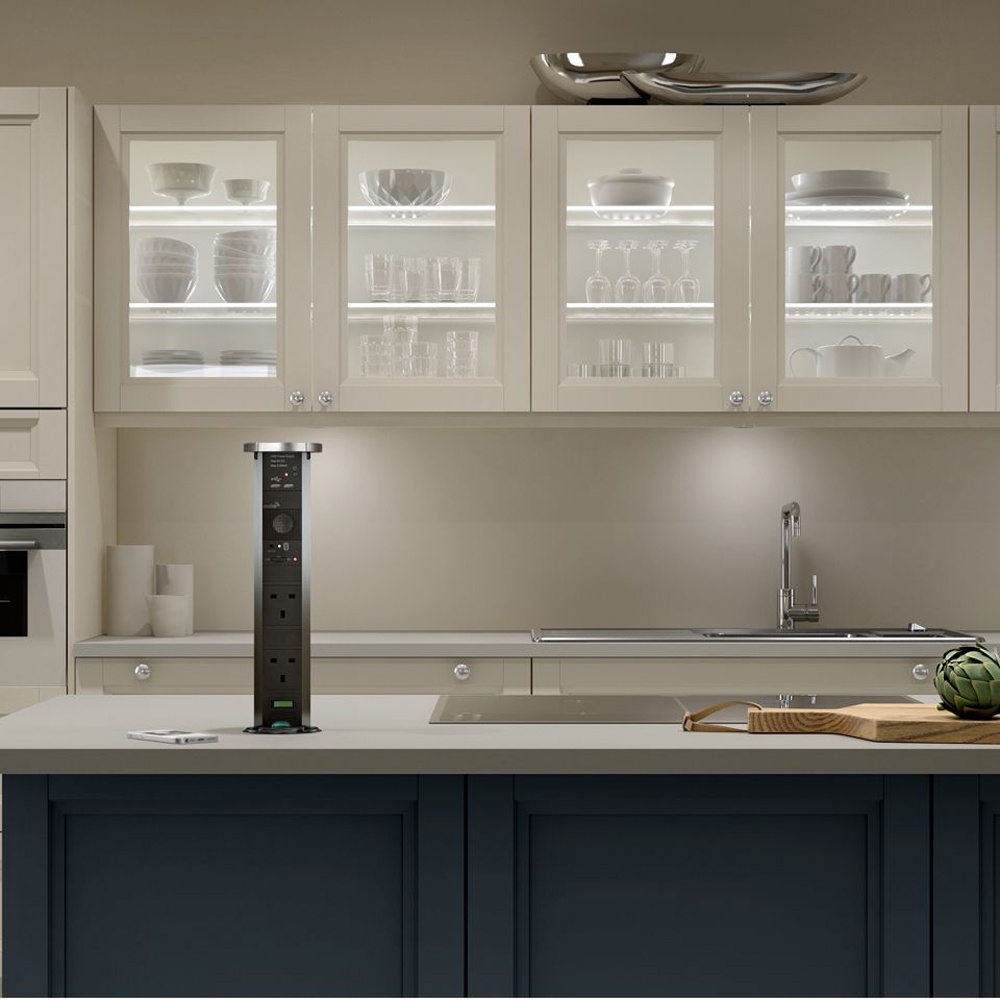 a kitchen island with a pop up electrical socket