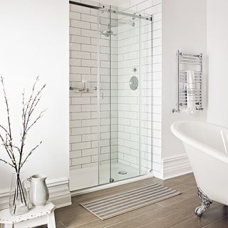 bathroom with white wall and shower room with sliding door