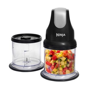 A stackable compact blender filled with chopped salsa