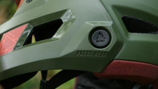 Close up photo of the release button. For the chin guard