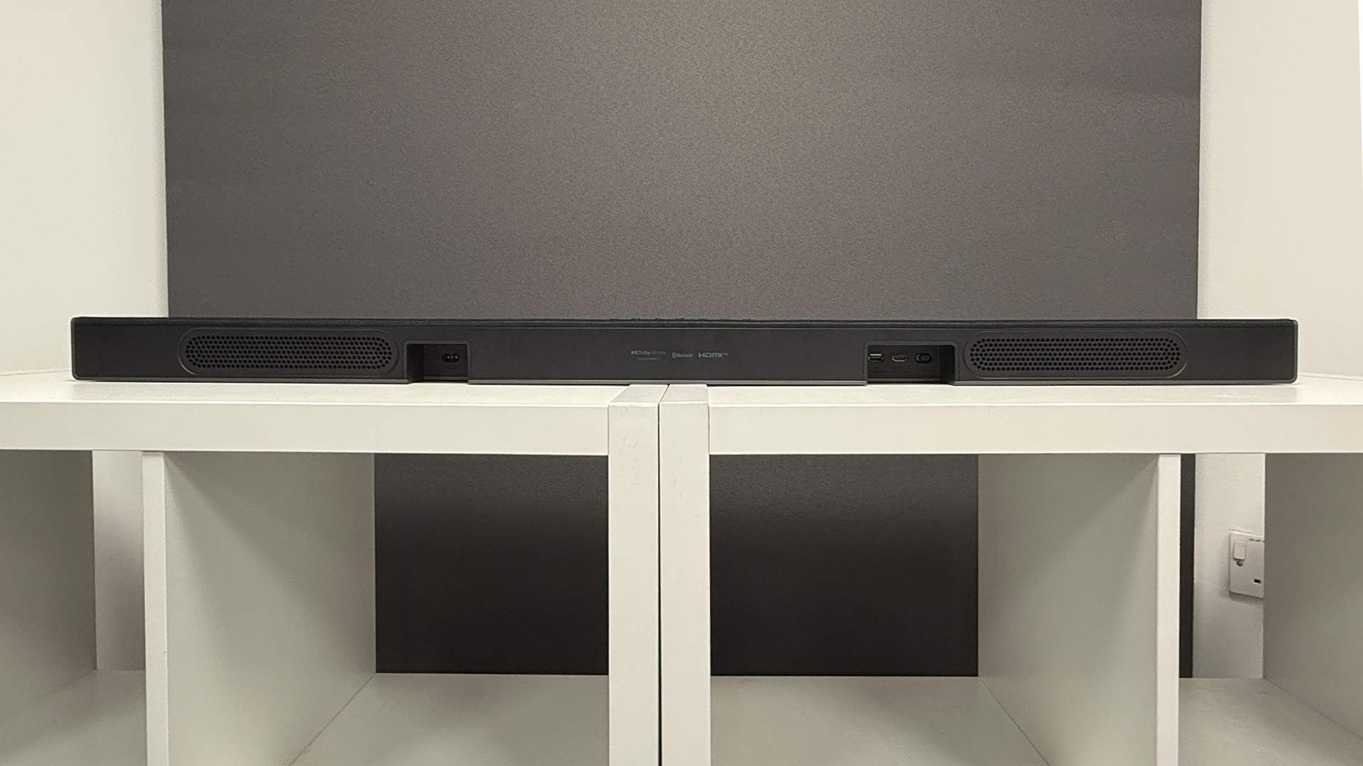 LG Sound Suite system soundbar system soundbar on white wooden shelving unit