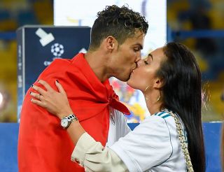 Cristiano Ronaldo kisses Georgina Rodriguez as they celebrate his side victory following winning the UEFA Champions League final between Real Madrid and Liverpool on May 26, 2018 in Kiev, Ukraine. (Photo by David Ramos/Getty Images)