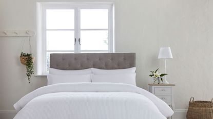 white bed with a grey headboard