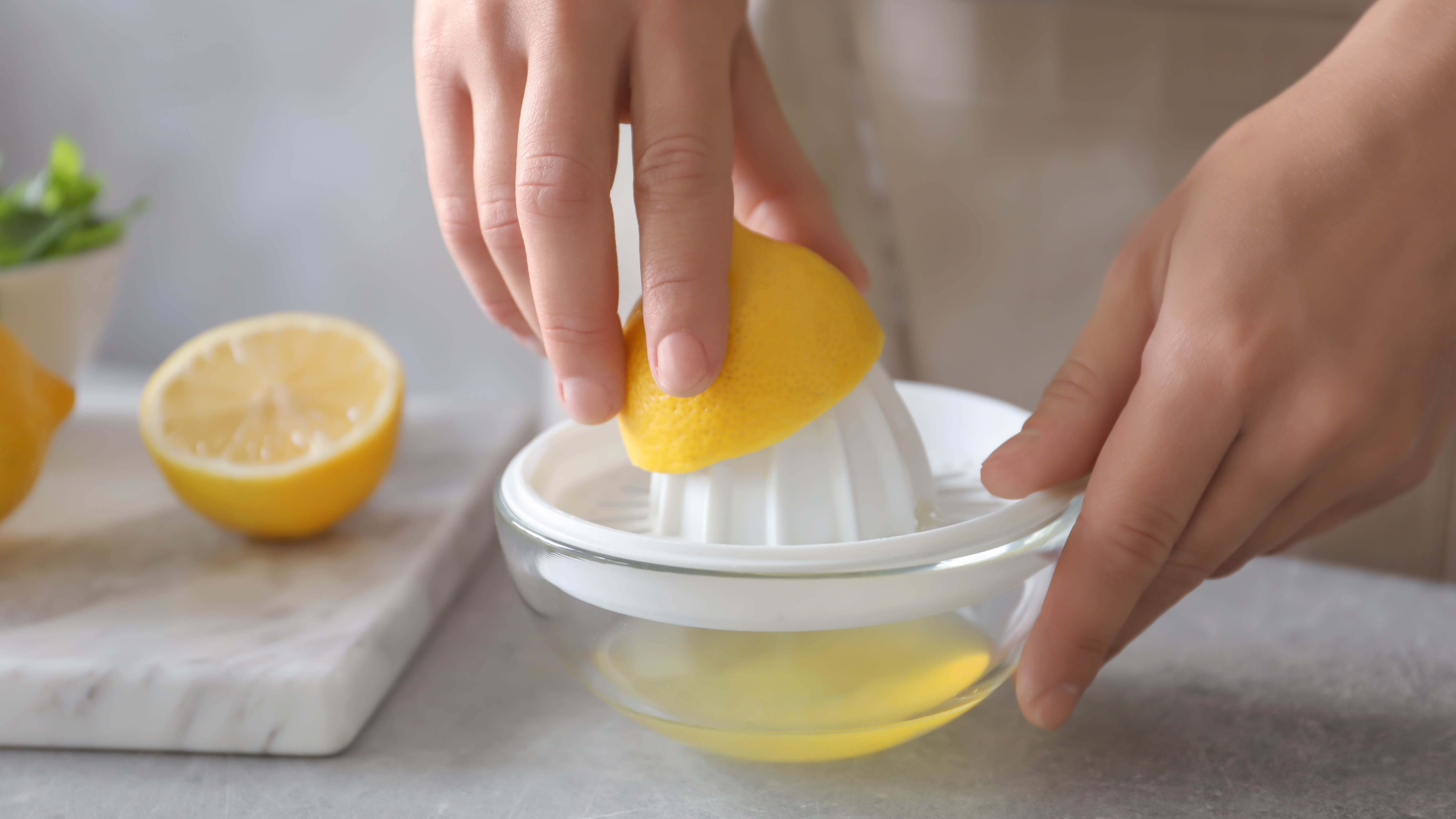 Squeezing a lemon into bowl