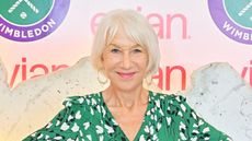 Helen Mirren at Evian lounge at Wimbledon in a green dress with white and black print