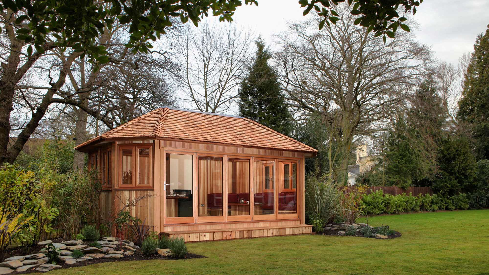 timber-clad garden office with shingle roof