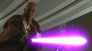 a bald man holds a purple light saber.
