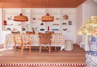 a dining room with a step painted with red and white stripes