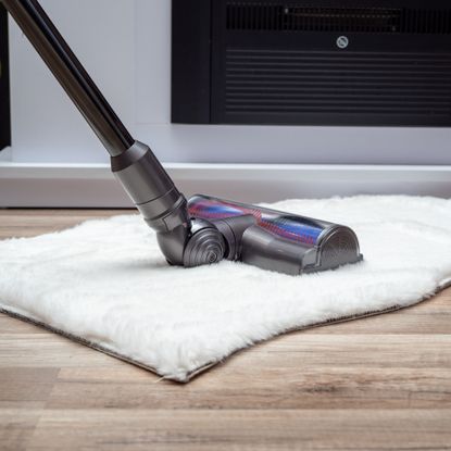 Cordless vacuum cleaner vacuuming floor