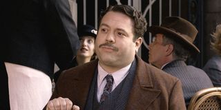 Jacob Kowalski (Dan Fogler) sits at an outdoor table in "Fantastic Beasts and Where To Find Them'