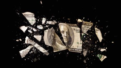 one-hundred dollar bill broken into many pieces