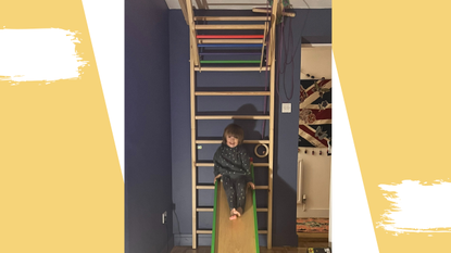 Image of a toddler on a wall cliber with a yellow background