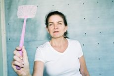 Woman Holding a Fly Swatter