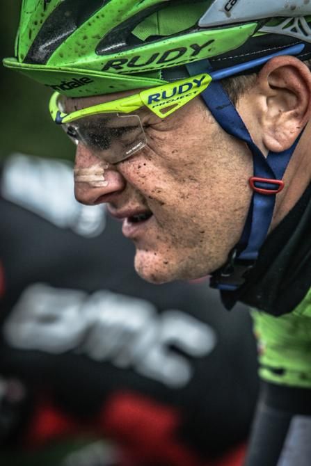 Ted King (Cannondale) squints as water splashes up from the wheels in front.