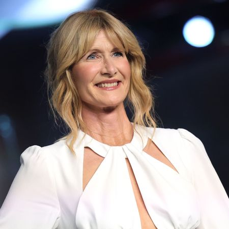 a white woman with blonde hair posing at a red carpet event